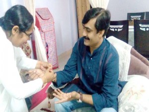 B.K. Preeti Tying Rakhi to Owner of Rai Bus Service